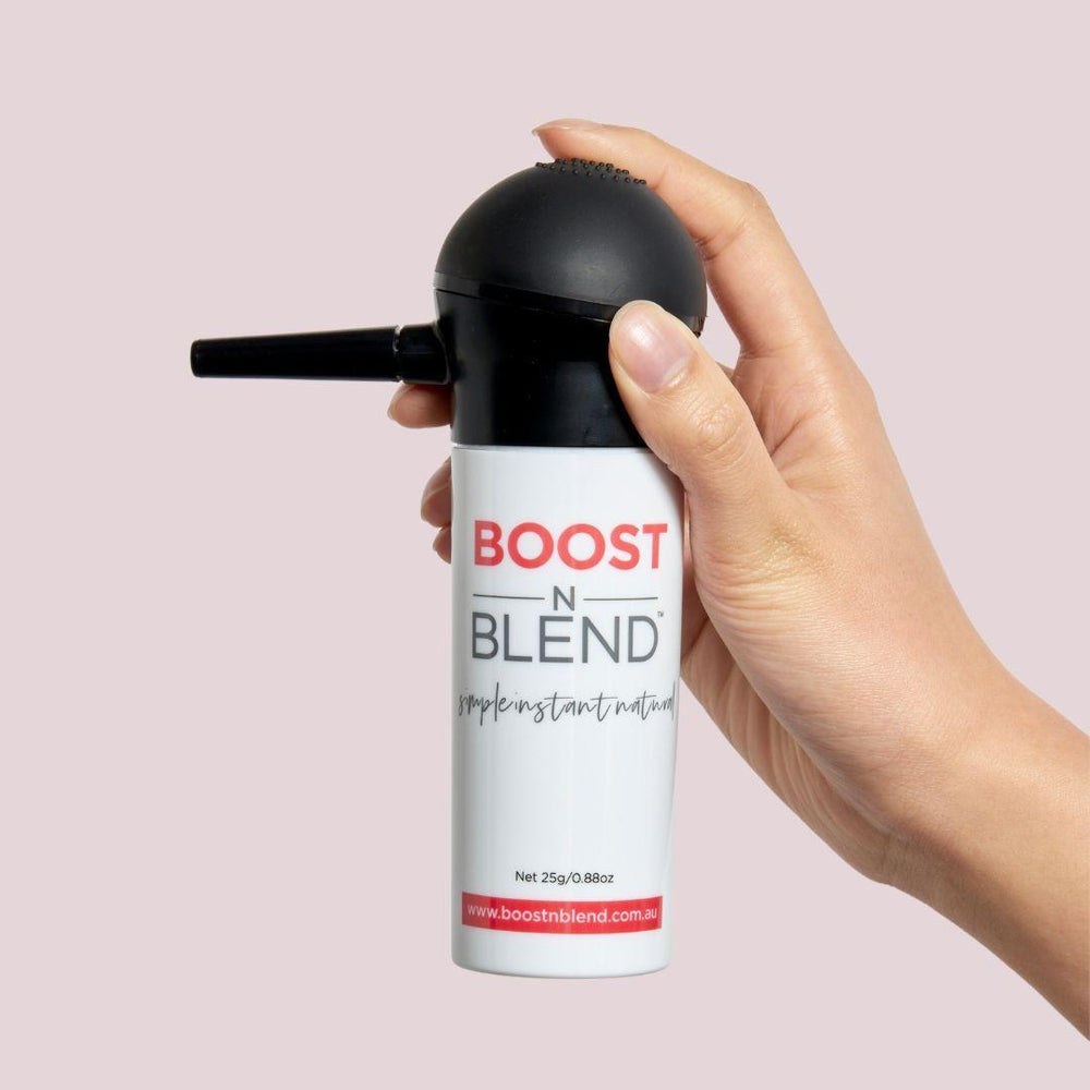 Boost N Blend Fibres and applicator hand shot #colour_dusky-dark-brown